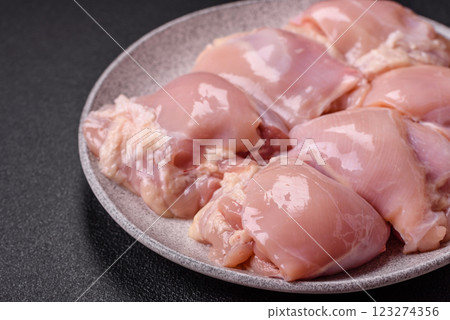 Fresh raw chicken thigh fillets with salt, spices and herbs 123274356