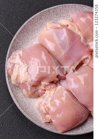 Fresh raw chicken thigh fillets with salt, spices and herbs 123274358