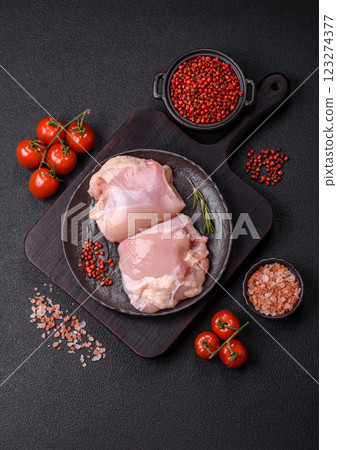 Fresh raw chicken thigh fillets with salt, spices and herbs 123274377