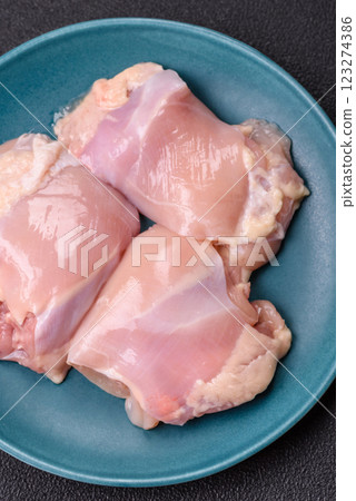 Fresh raw chicken thigh fillets with salt, spices and herbs Fresh raw chicken thigh fillets with salt, spices and herbs 123274386