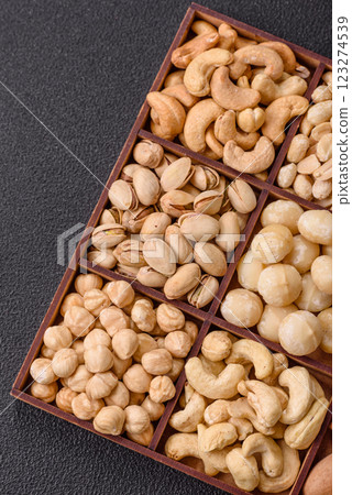 Box with various nuts cashew, macadamia, peanut, cedar, pecan, walnut, brazil, hazelnut 123274539