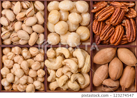 Box with various nuts cashew, macadamia, peanut, cedar, pecan, walnut, brazil, hazelnut 123274547