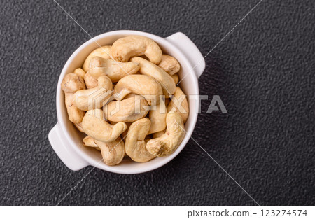 Delicious nutritious cashew nuts in ceramic bowl Delicious nutritious cashew nuts in ceramic bowl 123274574