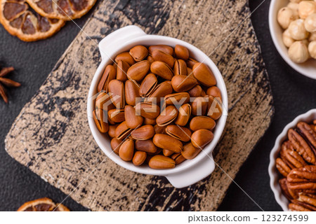 Delicious nutritious cedar nuts in ceramic bowl Delicious nutritious cedar nuts in ceramic bowl 123274599
