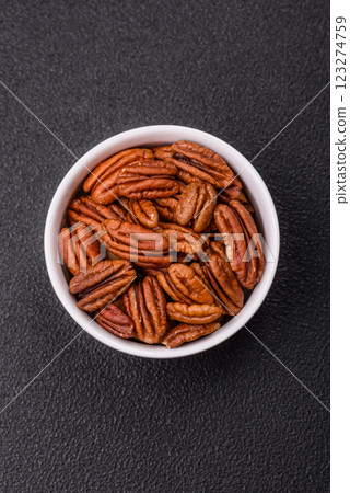 Delicious nutritious pecan nuts in ceramic bowl Delicious nutritious pecan nuts in ceramic bowl 123274759