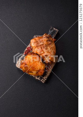 Delicious juicy chicken thighs baked with salt, spices and herbs 123275079