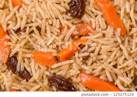 Delicious fresh pilaf with rice, carrots, meat, onions, spices and berries 123275120