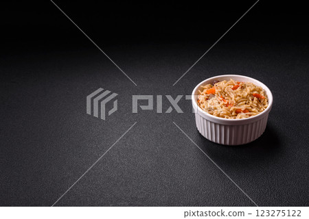 Delicious fresh pilaf with rice, carrots, meat, onions, spices and berries 123275122