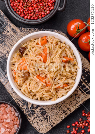 Delicious fresh pilaf with rice, carrots, meat, onions, spices and berries Delicious fresh pilaf with rice, carrots, meat, onions, spices and berries 123275130
