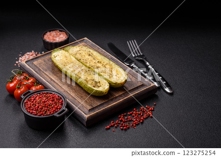 Delicious zucchini cut into two halves baked with salt, spices and herbs 123275254