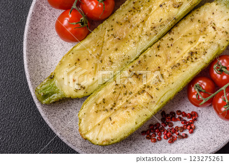 Delicious zucchini cut into two halves baked with salt, spices and herbs Delicious zucchini cut into two halves baked with salt, spices and herbs 123275261