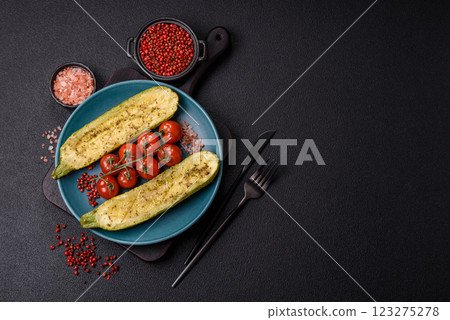 Delicious zucchini cut into two halves baked with salt, spices and herbs Delicious zucchini cut into two halves baked with salt, spices and herbs 123275278
