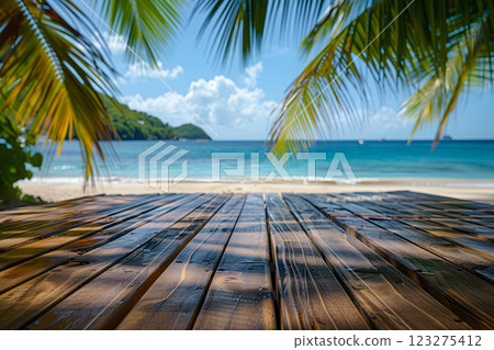 A wooden deck providing a stunning view of a tropical beach lined with palm trees, under the azure sky with fluffy clouds, surrounded by a natural landscape A wooden deck providing a stunning view of a tropical beach lined with palm trees, under the azure sky with fluffy clouds, surrounded by a natural landscape 123275412