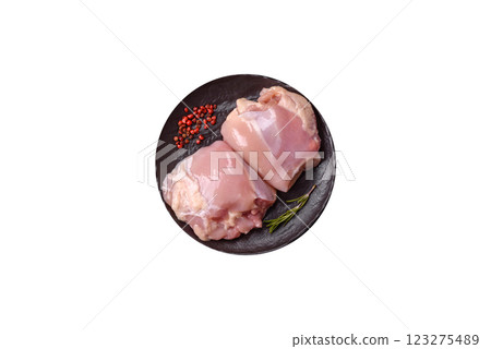 Fresh raw chicken thigh fillets with salt, spices and herbs Fresh raw chicken thigh fillets with salt, spices and herbs 123275489