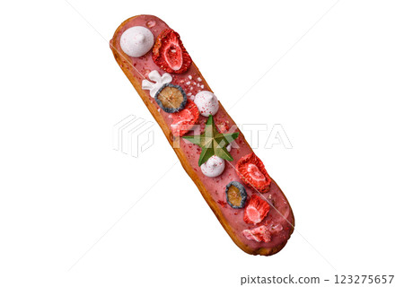 Sweet eclair with chocolate filling, decorated for Christmas Sweet eclair with chocolate filling, decorated for Christmas 123275657