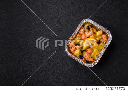 Baked salmon pieces with potatoes, cheese and olives Baked salmon pieces with potatoes, cheese and olives 123275770