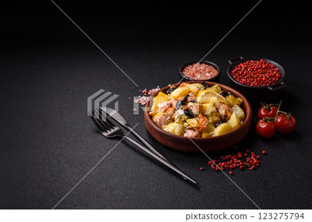 Baked salmon pieces with potatoes, cheese and olives Baked salmon pieces with potatoes, cheese and olives 123275794