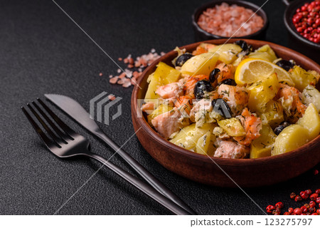 Baked salmon pieces with potatoes, cheese and olives Baked salmon pieces with potatoes, cheese and olives 123275797