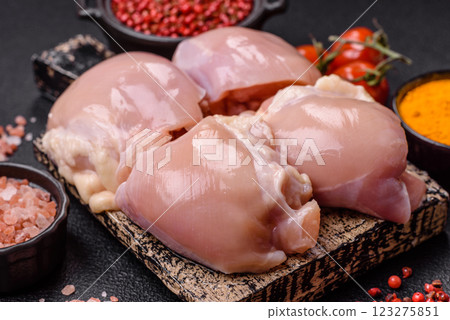 Fresh raw chicken thigh fillets with salt, spices and herbs Fresh raw chicken thigh fillets with salt, spices and herbs 123275851