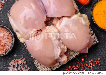 Fresh raw chicken thigh fillets with salt, spices and herbs Fresh raw chicken thigh fillets with salt, spices and herbs 123275852