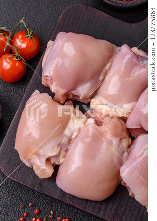 Fresh raw chicken thigh fillets with salt, spices and herbs 123275863