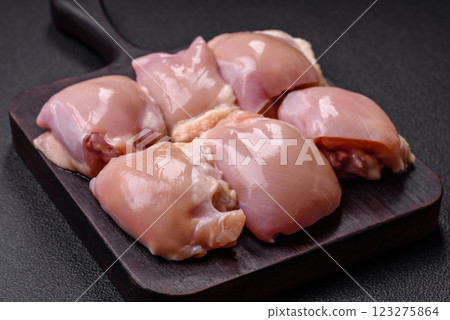 Fresh raw chicken thigh fillets with salt, spices and herbs 123275864