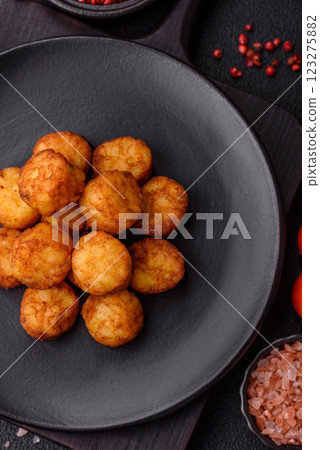 Delicious fried potato balls or croquettes with salt, spices and herbs 123275882
