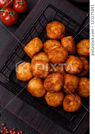 Delicious fried potato balls or croquettes with salt, spices and herbs Delicious fried potato balls or croquettes with salt, spices and herbs 123275891