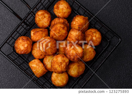 Delicious fried potato balls or croquettes with salt, spices and herbs Delicious fried potato balls or croquettes with salt, spices and herbs 123275893