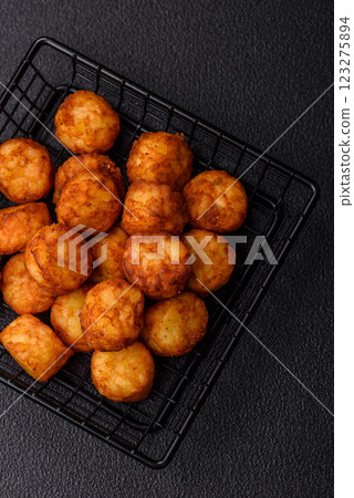 Delicious fried potato balls or croquettes with salt, spices and herbs Delicious fried potato balls or croquettes with salt, spices and herbs 123275894