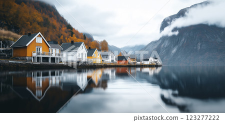 Colorful coastal houses reflect on serene waters amidst autumn foliage in a tranquil Norwegian fjord. Generative AI 123277222