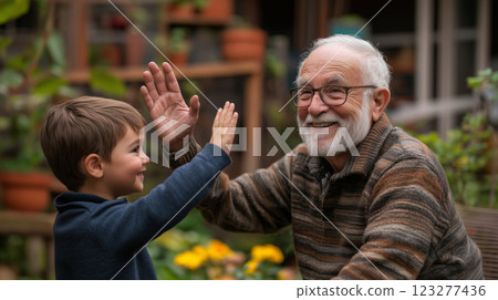 Joyful moment shared between grandfather and grandson in a garden Joyful moment shared between grandfather and grandson in a garden 123277436