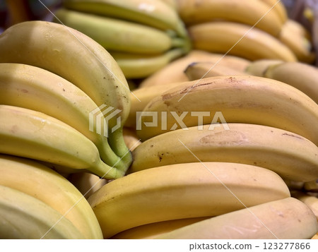 Ripe juicy yellow bananas close-up on a shelf in a supermarket. Close-up. 123277866
