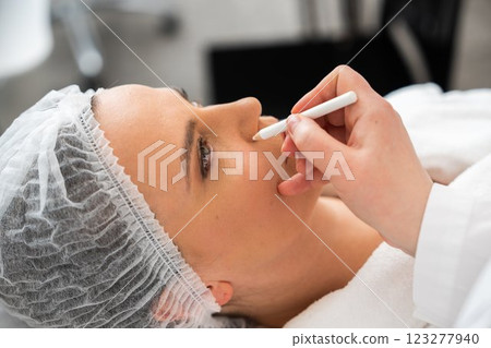 Beauty treatment session with client in spa setting during daylight hours Beauty treatment session with client in spa setting during daylight hours 123277940