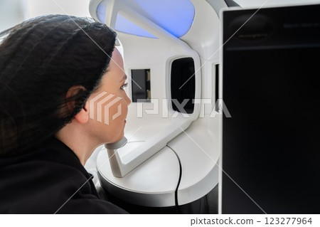 Woman undergoing skin analysis in a modern clinic setting Woman undergoing skin analysis in a modern clinic setting 123277964