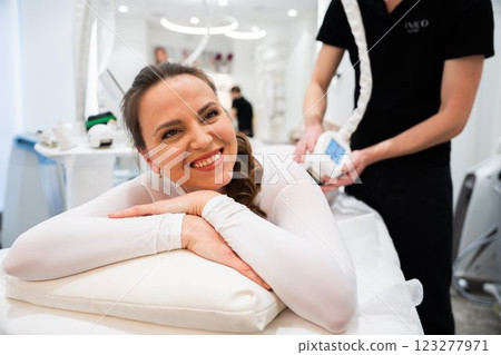 Client enjoying a relaxing wellness treatment in a modern spa setting Client enjoying a relaxing wellness treatment in a modern spa setting 123277971