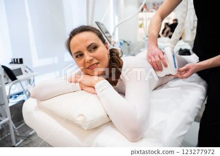 Woman receiving a skin treatment in a modern beauty clinic facility Woman receiving a skin treatment in a modern beauty clinic facility 123277972