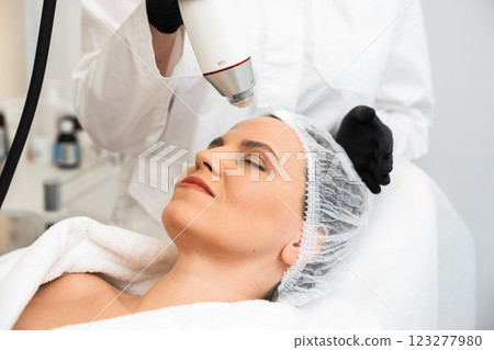 Woman receiving facial treatment at beauty clinic on a sunny day Woman receiving facial treatment at beauty clinic on a sunny day 123277980