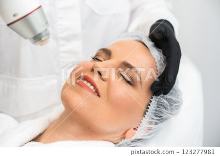 Woman receiving a facial treatment in a modern skincare clinic 123277981