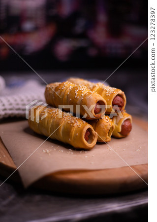 Homemade sausages in dough with sesame seeds close-up Homemade sausages in dough with sesame seeds close-up 123278397