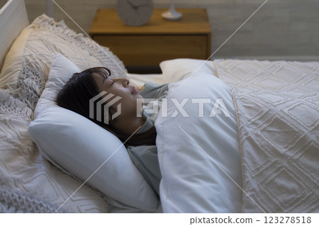 A young woman sleeping in bed A young woman sleeping in bed 123278518