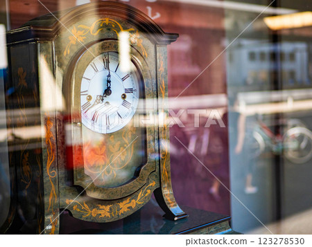 An old clock displayed in a shop window An old clock displayed in a shop window 123278530
