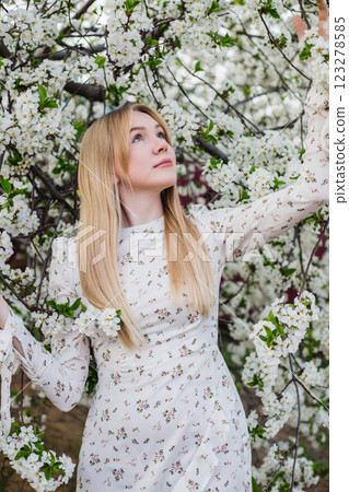 Beautiful blonde girl in a spring cherry blossom garden. Cover photo Beautiful blonde girl in a spring cherry blossom garden. Cover photo 123278585