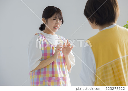 A woman wearing an apron speaking A woman wearing an apron speaking 123278622