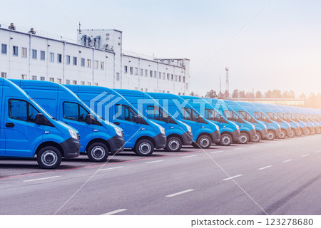 Freight trucks stand by the storage building. 123278680