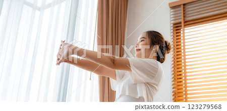 Young Asian beautiful woman doing stretch in the morning at home. Health care and body care concept 123279568