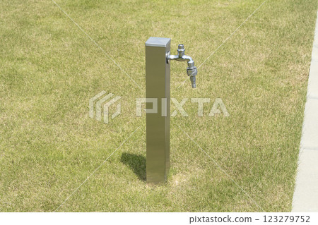 A water tap installed on the lawn 123279752