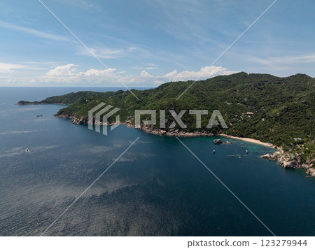 Pristine bay featuring turquoise water, green hills, and a tranquil atmosphere with scattered boats. Koh Tao, Thailand. 123279944