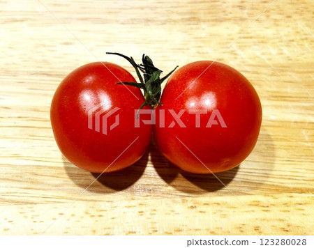 Two cherry tomatoes with their stems stuck together 2 Two cherry tomatoes with their stems stuck together 2 123280028