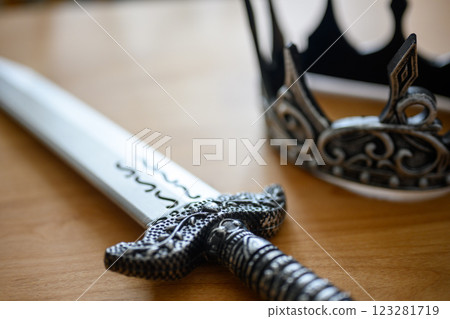 Sword and crown on the table Sword and crown on the table 123281719
